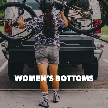 Person standing next to a truck with 'Women's Bottoms' text overlay.