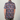 Person wearing a colorful floral patterned shirt on a plain background