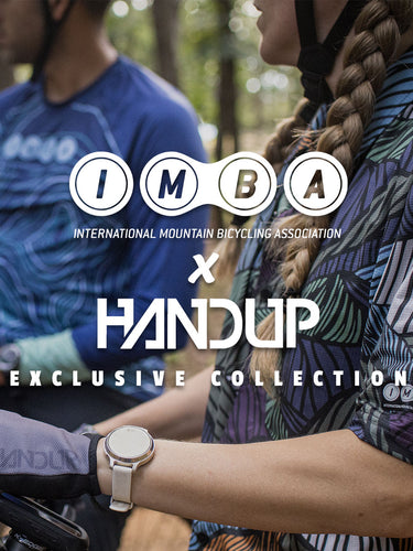Two people in mountain biking gear with 'IMBA' and 'Handup' logos overlayed.