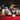 Two men playing pool in a bar with festive decorations.