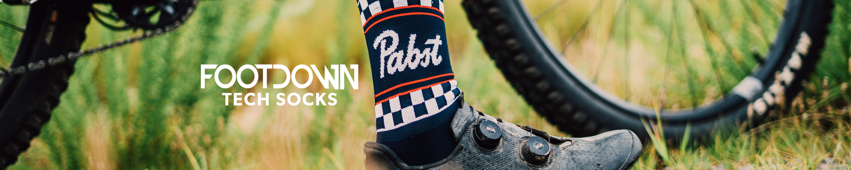 Person wearing Pabst branded socks with a bike in the background