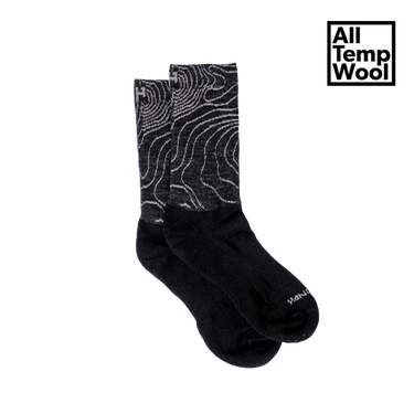 A pair of black wool socks with a white geometric pattern