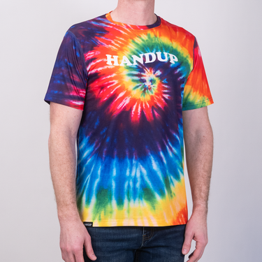 Person wearing a tie-dye t-shirt with 'HANDUP' text on a plain background