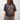 Person wearing a black t-shirt with white graphic design on the back against a plain background